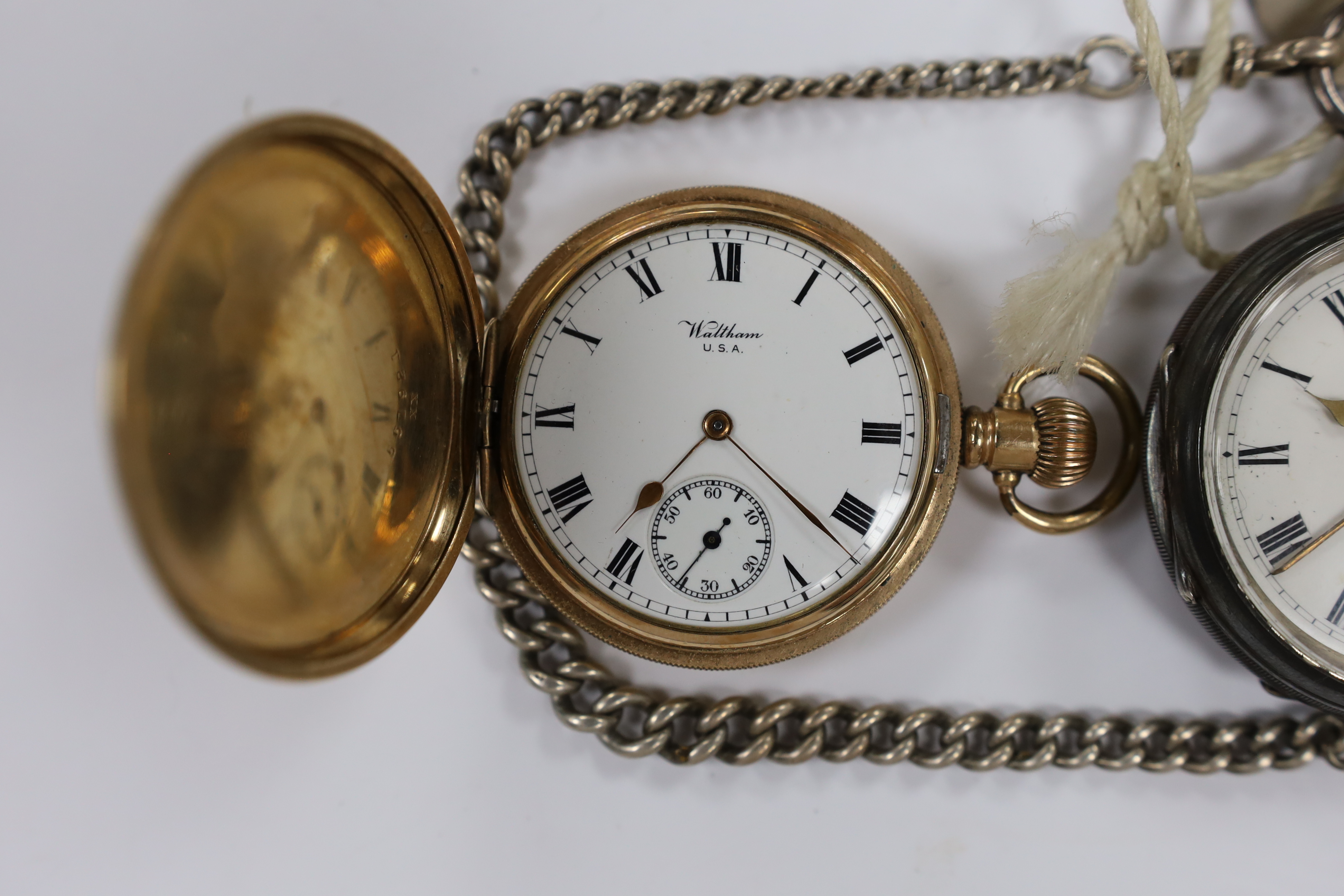 A George V silver open face keywind pocket watch by Ellis Branskey of Newcastle, on a graduated silver curb link albert, together with a gold plated Waltham hunter pocket watch and a Swiss 935 white metal half hunter fob